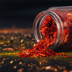 A still life photo of pink saffron flakes, one of the key fragrance notes in the "Citrus and Peppercorn" scented candle from Tuscany Candle's "Homme & Heritage" collection of manly candles