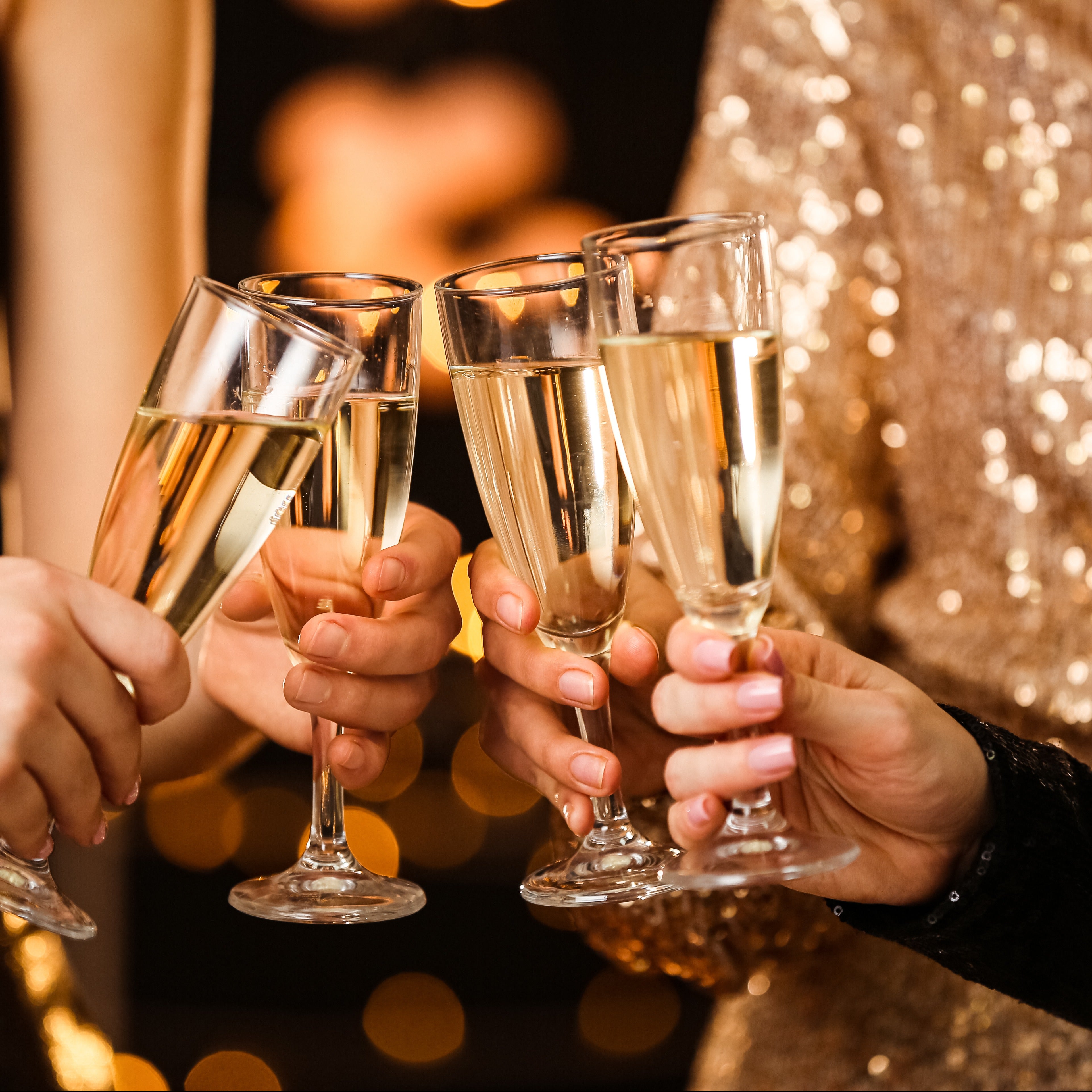 Women toasting Lavender Champagne Scented Jar Candles (14 oz) at a winter party.